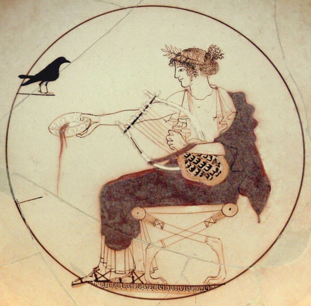 Apollo wearing a laurel or myrtle wreath, a white peplos and a red himation and sandals, seating on a lion-pawed diphros; he holds a kithara in his left hand and pours a libation with his right hand. Facing him, a black bird identified as a pigeon, a jackdaw, a crow (which may allude to his love affair with Coronis) or a raven (a mantic bird). Tondo of an Attic white-ground kylix attributed to the Pistoxenos Painter (or the Berlin Painter, or Onesimos). Diam. 18 cm (7 in.). From a tomb (probably that of a priest) in Delphi. Archaeological Museum of Delphi, Inv. 8140, room XII.